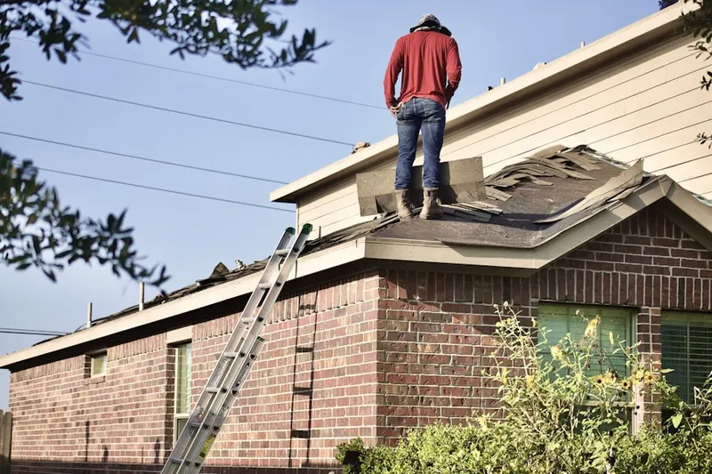 Professional roofer working on a residential roof in Foxcroft